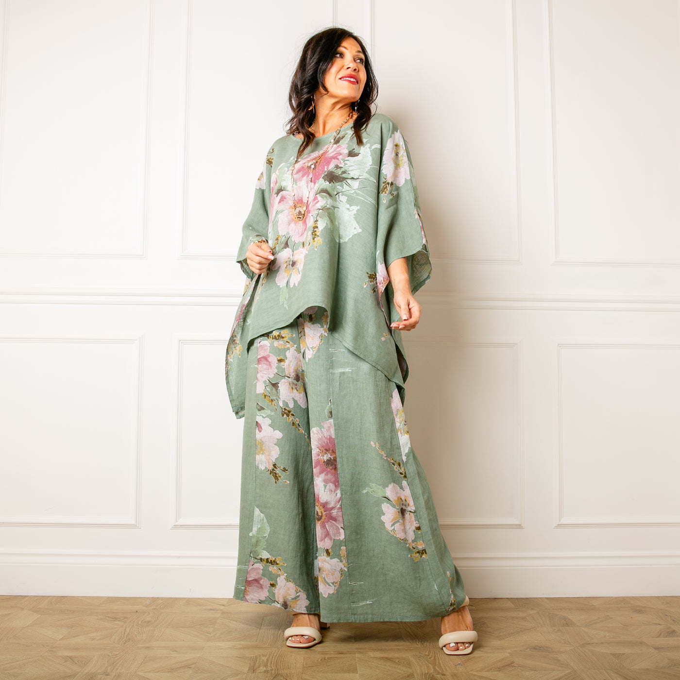 The sage green Bouquet Print Linen Trousers in a wide leg silhouette with pockets on either side