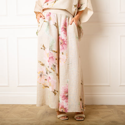 The stone cream Bouquet Print Linen Trousers in a wide leg silhouette with pockets on either side