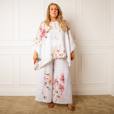 The white Bouquet Print Linen Trousers featuring a large beautiful floral print perfect for summer